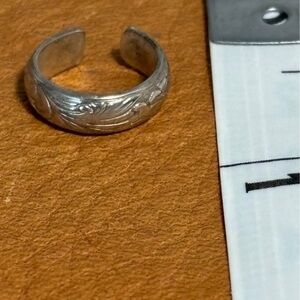 Tooled silver ear cuff.